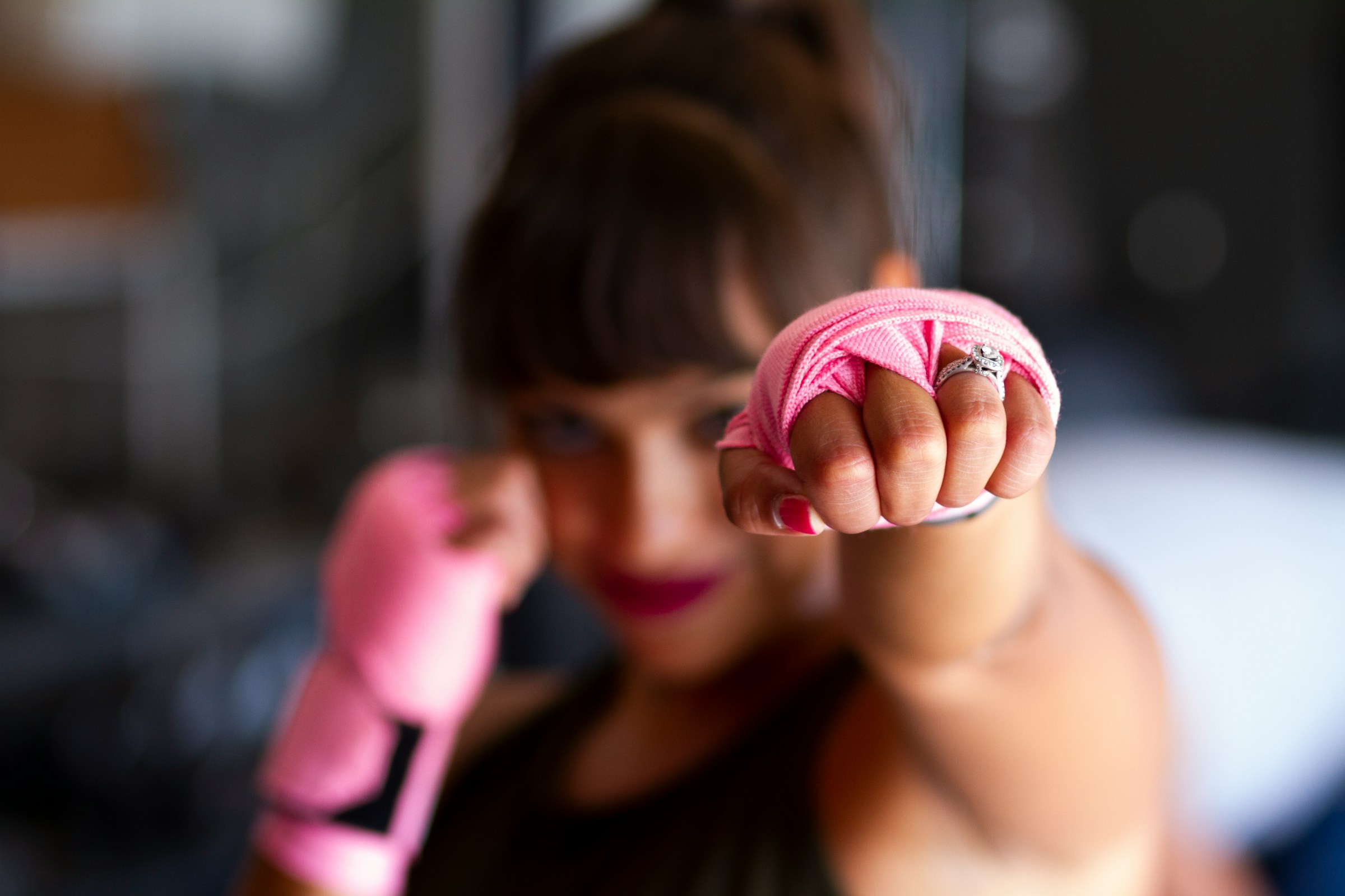 Woman punching illustrating the launch of Holistic AI open-source tools to counter artificial intelligence software development risks and algorithmic bias.