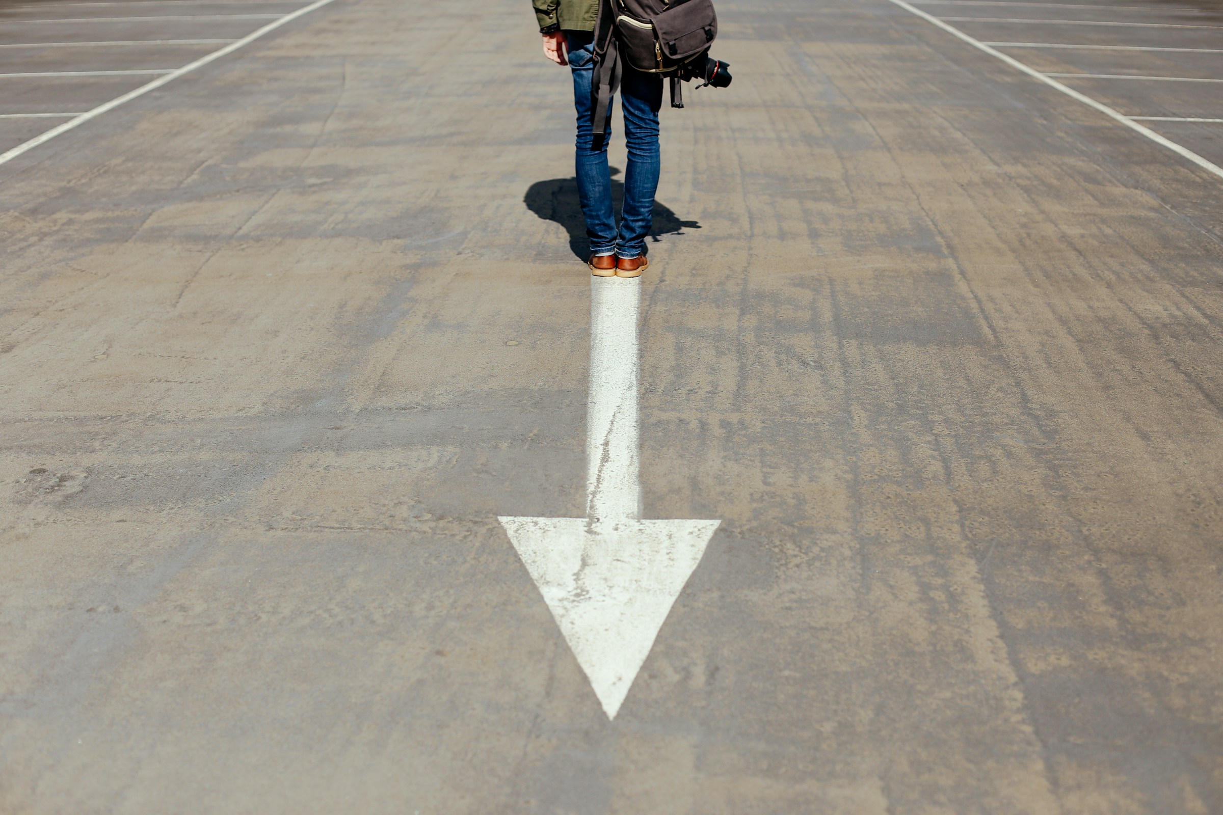 Person standing on a downward arrow suggestive of platform engineering falling short of expectations in embedded software.