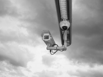 A security camera surrounded by clouds.