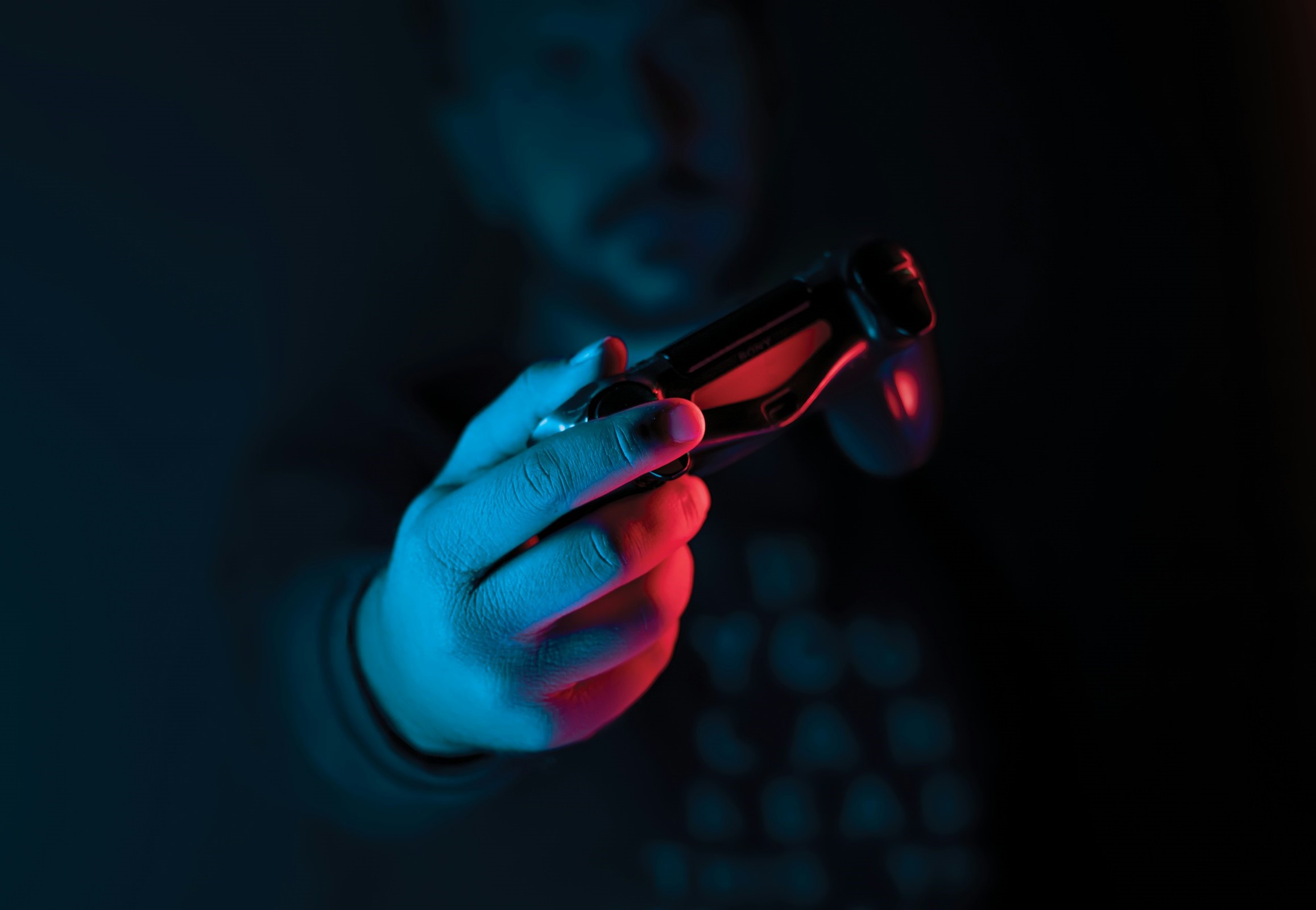 Person holding a gaming controller to illustrate the launch of the Unity 6 game development platform.